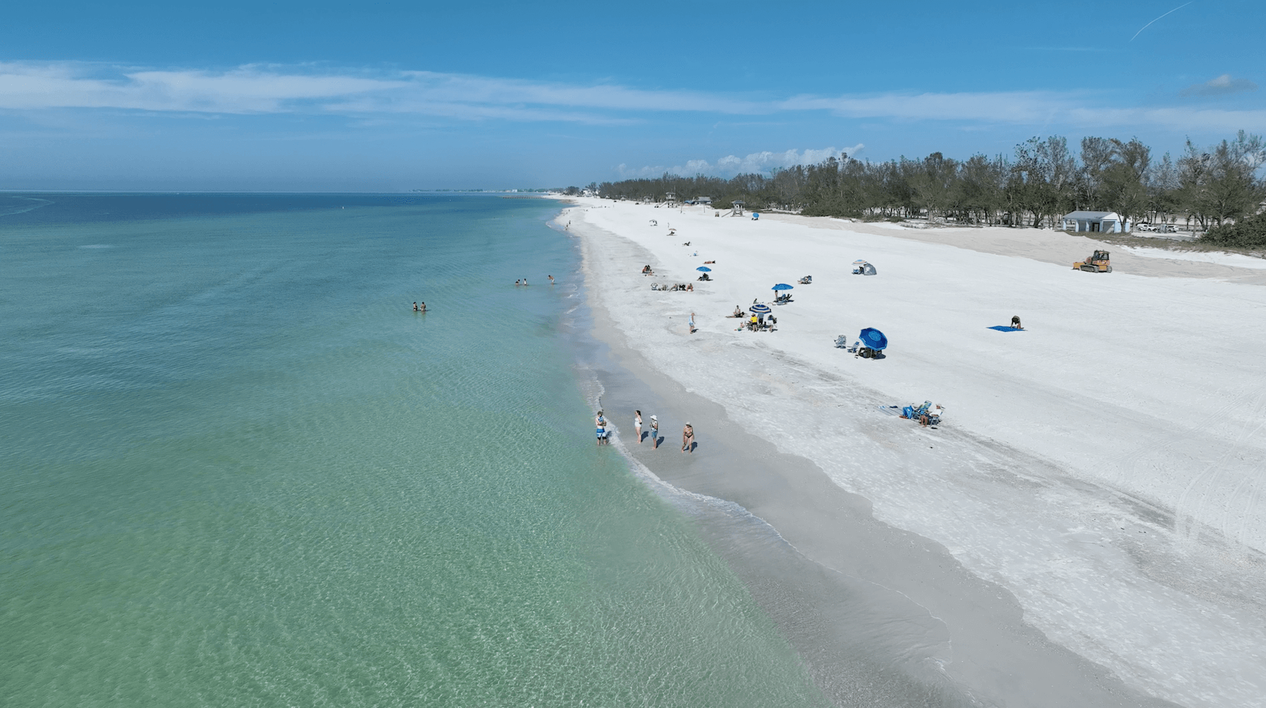 Coquina Beach with beachgoers on a bright sunny day